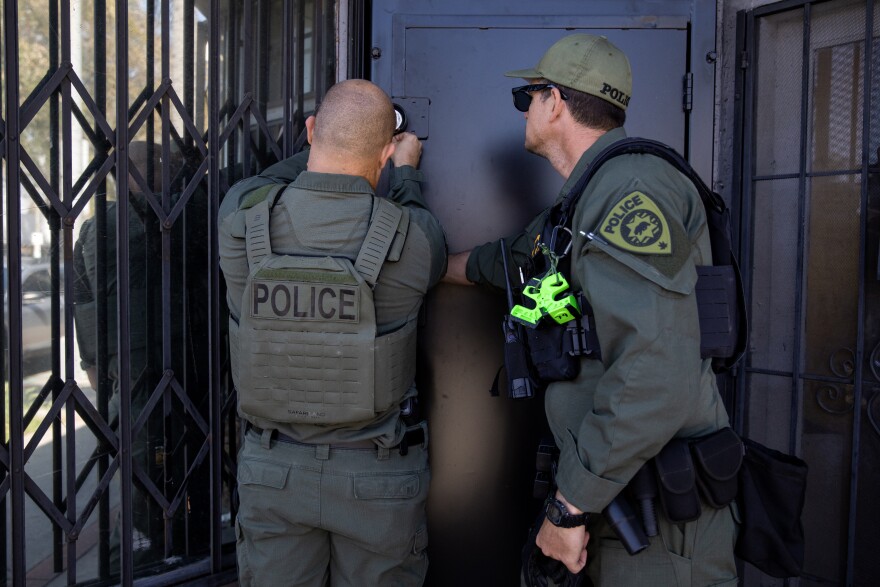 California Department of Cannabis Control detectives lock the premises after serving a search warrant on an unlicensed dispensary in Long Beach, Calif., on March 5, 2024. The penalty for unlicensed cannabis sales is usually a fine, and officers raid the some addresses over and over.