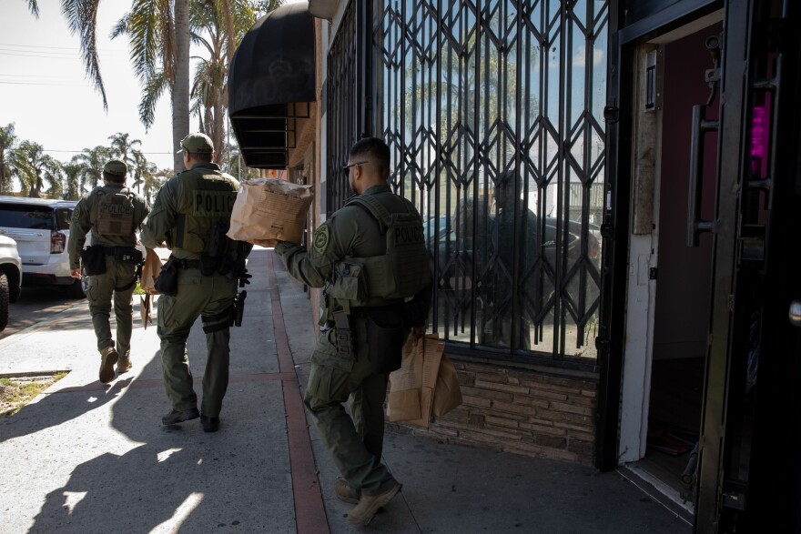 California Department of Cannabis Control detectives, with support of Long Beach Law enforcement serve a search warrant and remove cannabis products at an unlicensed dispensary in Long Beach, Calif., on March 5, 2024.