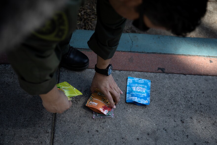 Wilson Linares, commander of the L.A. County law enforcement division of the California Dept. of Cannabis Control, shows a sampling of the unlicensed cannabis edibles seized from a black market store in Long Beach, Calif., on March 5.